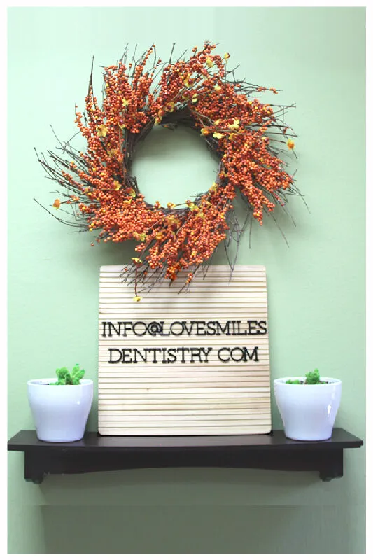 Autumn wreath above a letter board reading info@lovesmilesdentistry.com